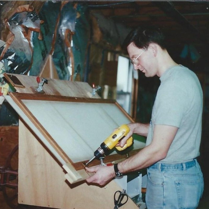 Ghent craftmanship, man drilling a display case.
